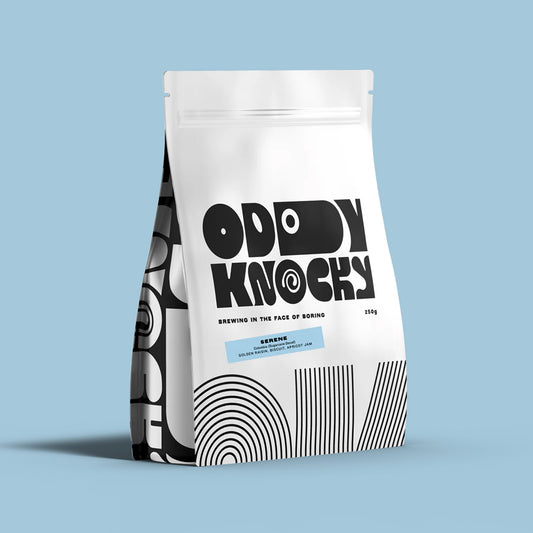 Serene Decaf Coffee packaging from Oddly Knocky displaying modern art design on a blue background.