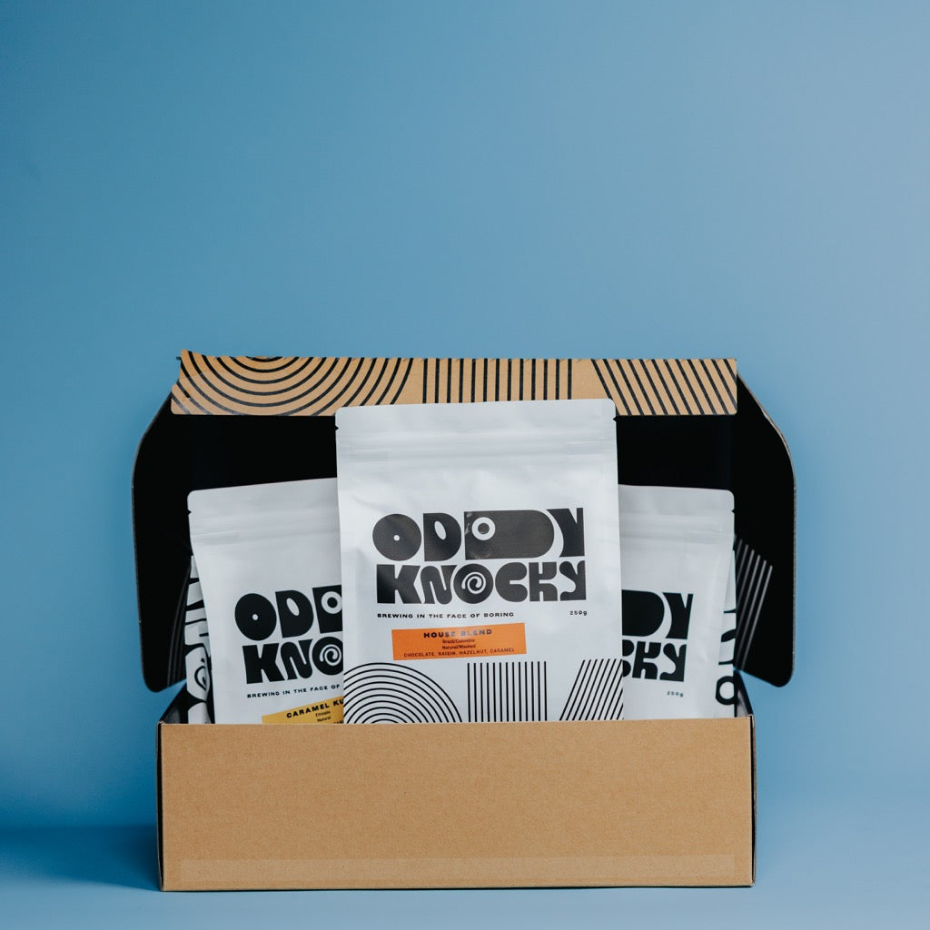 Espresso Gift Bundle featuring three specialty coffee bags in a stylish box against a blue background.