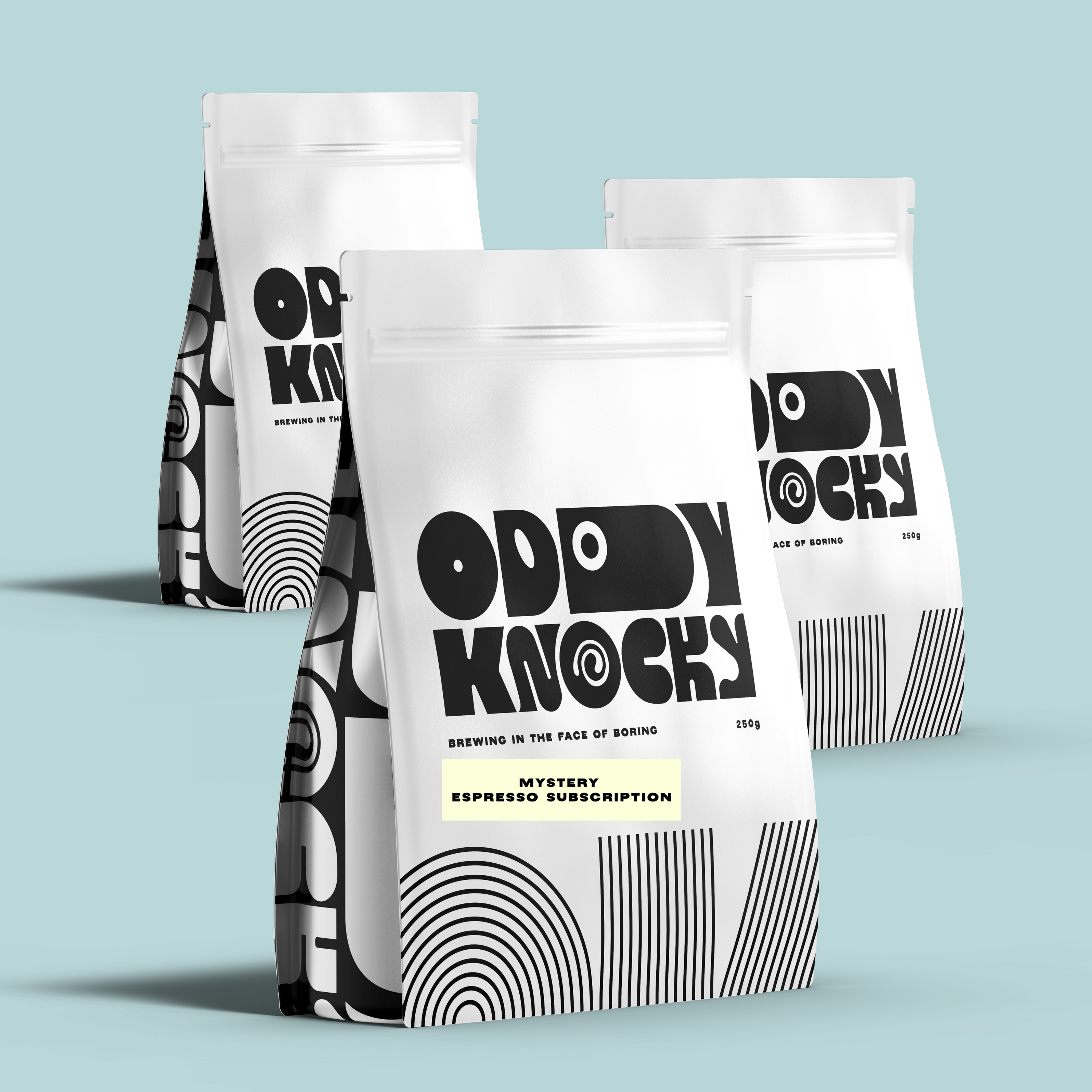 Three bags of Oddy Knocky Mystery Espresso Subscription on a blue background.