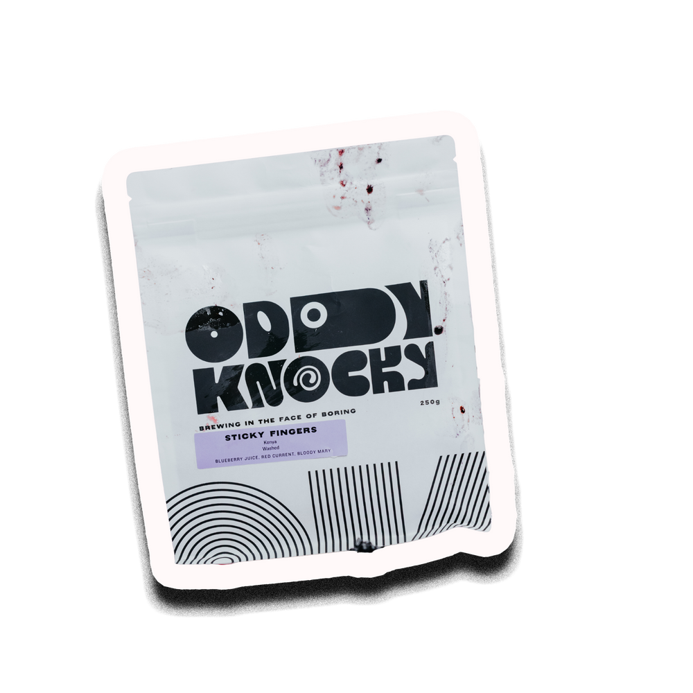 A stand-up pouch of Oddy Knocky Sticky Fingers sauce, featuring a white background with black graphic text and design elements, including a small red splatter detail, set against a plain white background.
